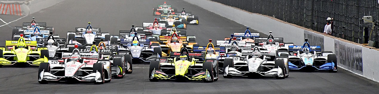 indy cars racing to through the start line Ann Arbor